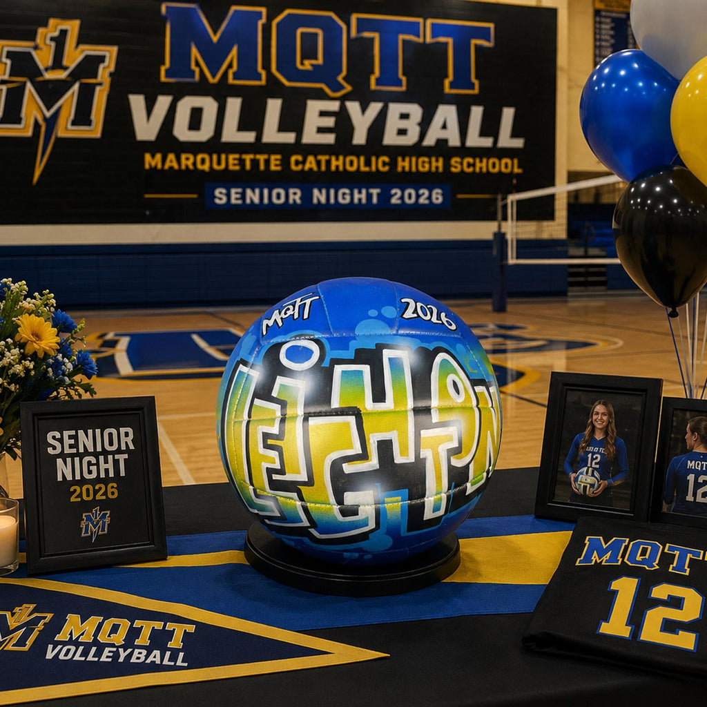 a senior night decorated table with a custom volleyball personalized with the name Leighton, trophy with the year 2016, surrounded by framed photos of volleyball players and a sign that reads "SENIOR NIGHT 2016".
