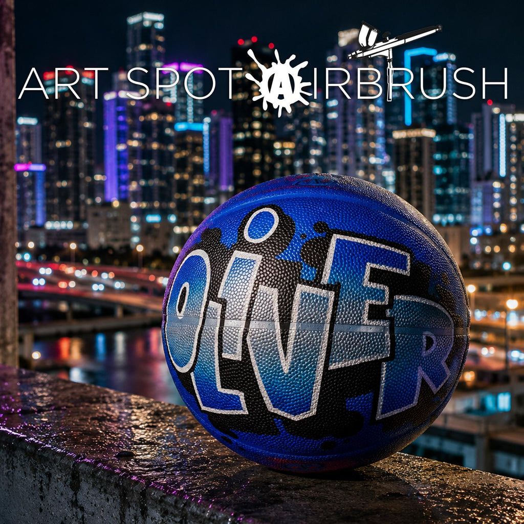 A basketball with the name "OLIVER" painted on it, sitting on a ledge against a backdrop of a city skyline at night.