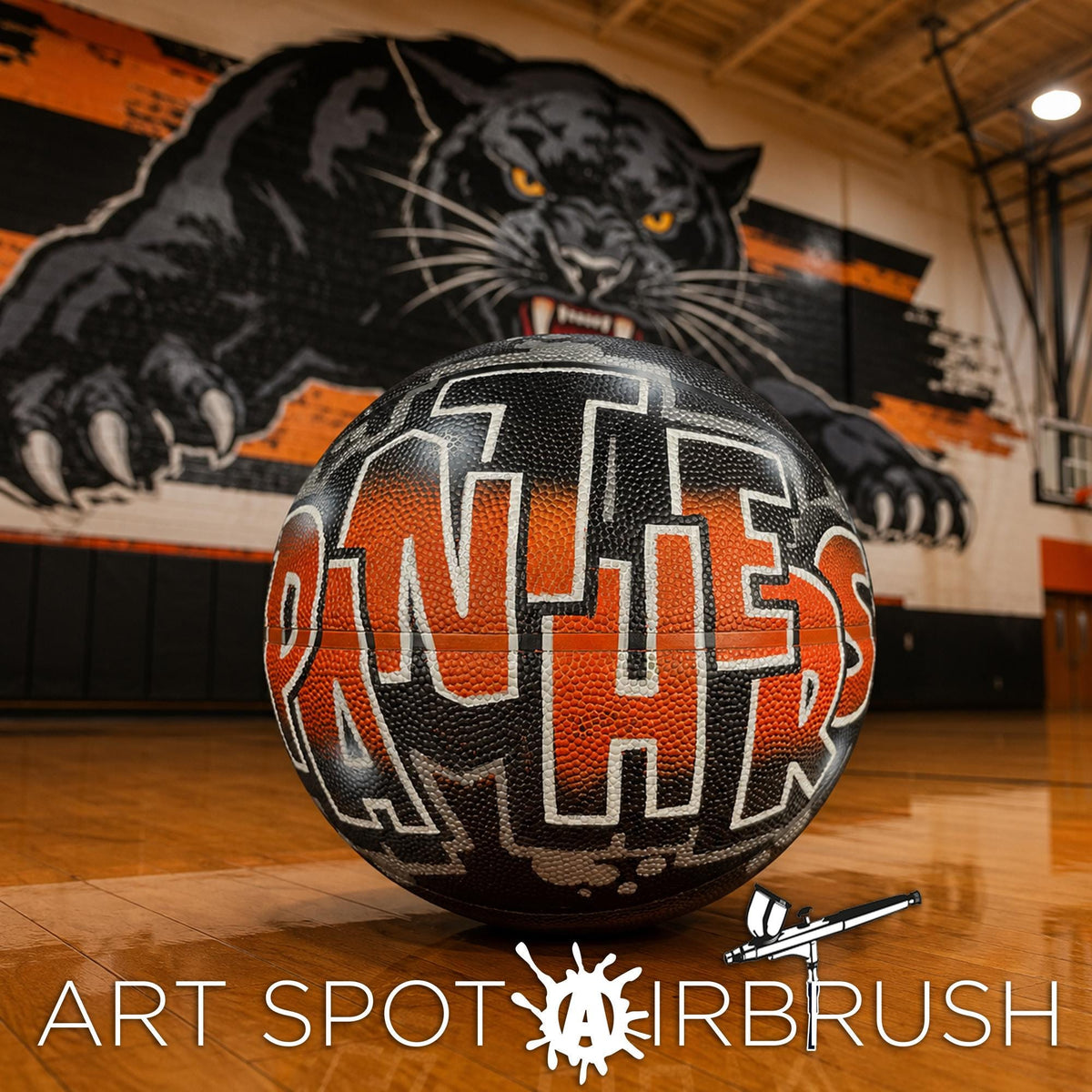 A basketball with the word "Panthers" written on it, placed on a basketball court with a large black panther mural in the background.