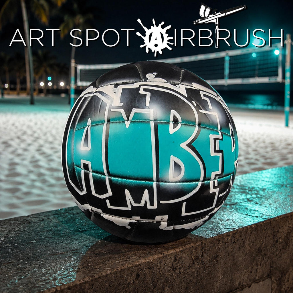 a custom volleyball with the letters "Amber" painted on it, sitting on a ledge or surface.