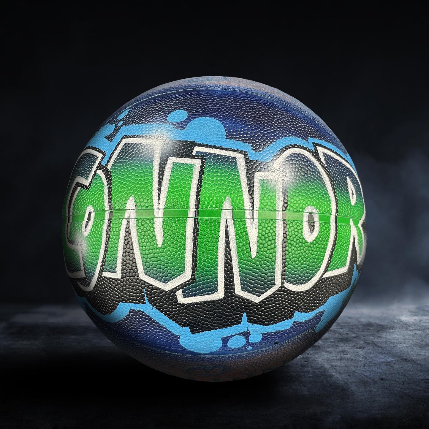 A basketball with the word "NOR" painted on it in graffiti-style lettering.