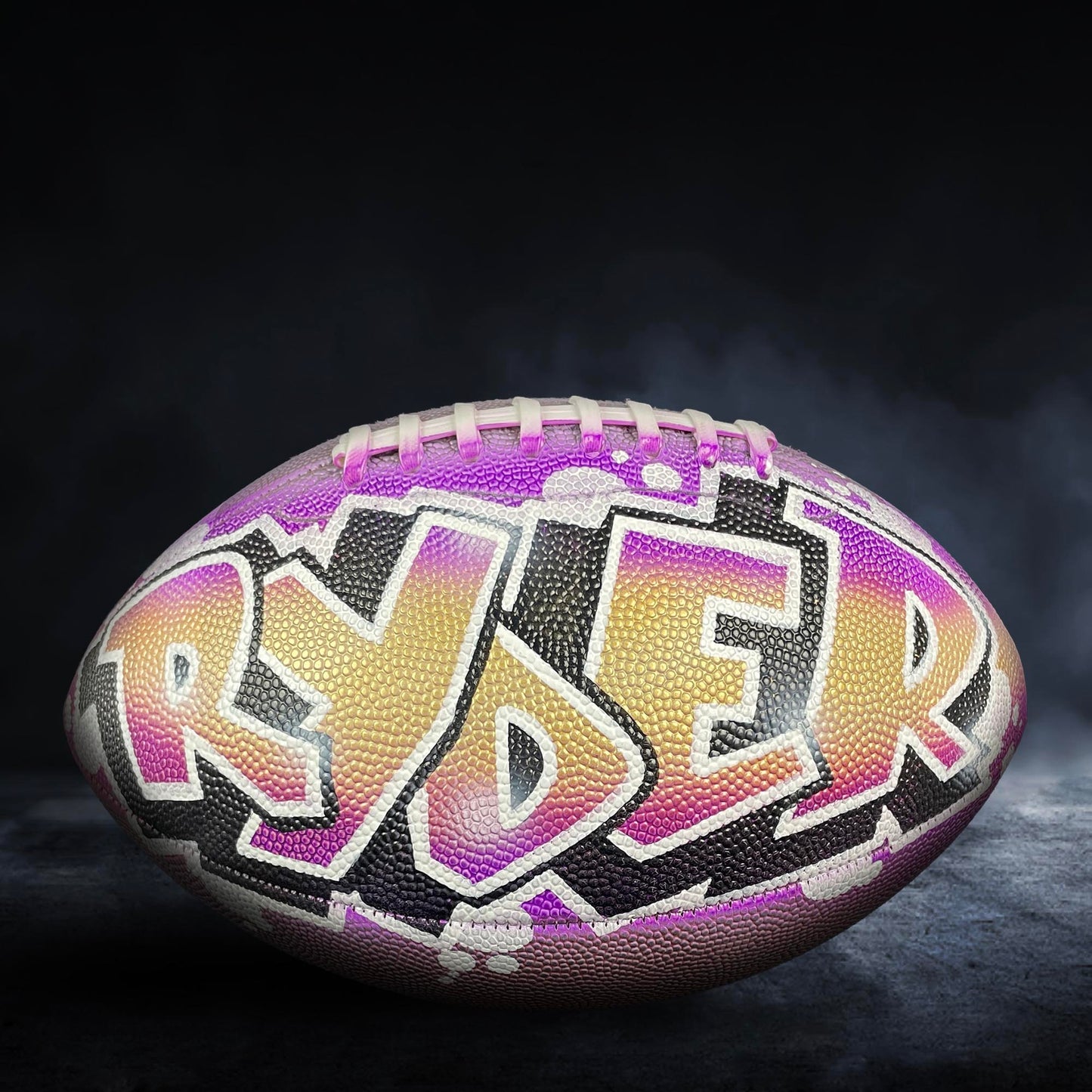 A football with the name "Reyer" painted on it, featuring a colorful and artistic design.