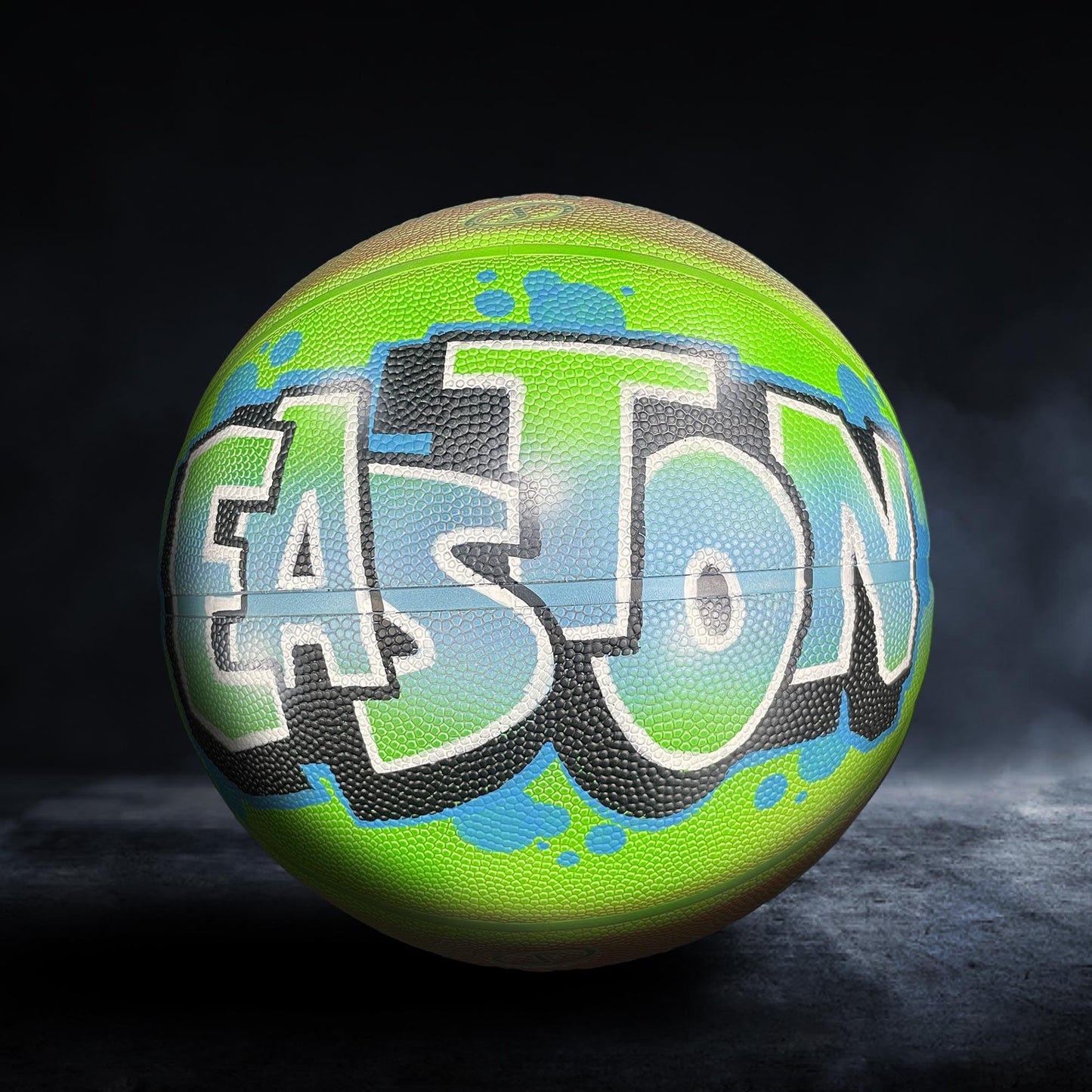 A basketball with the word "EASTON" painted on it in graffiti-style lettering.