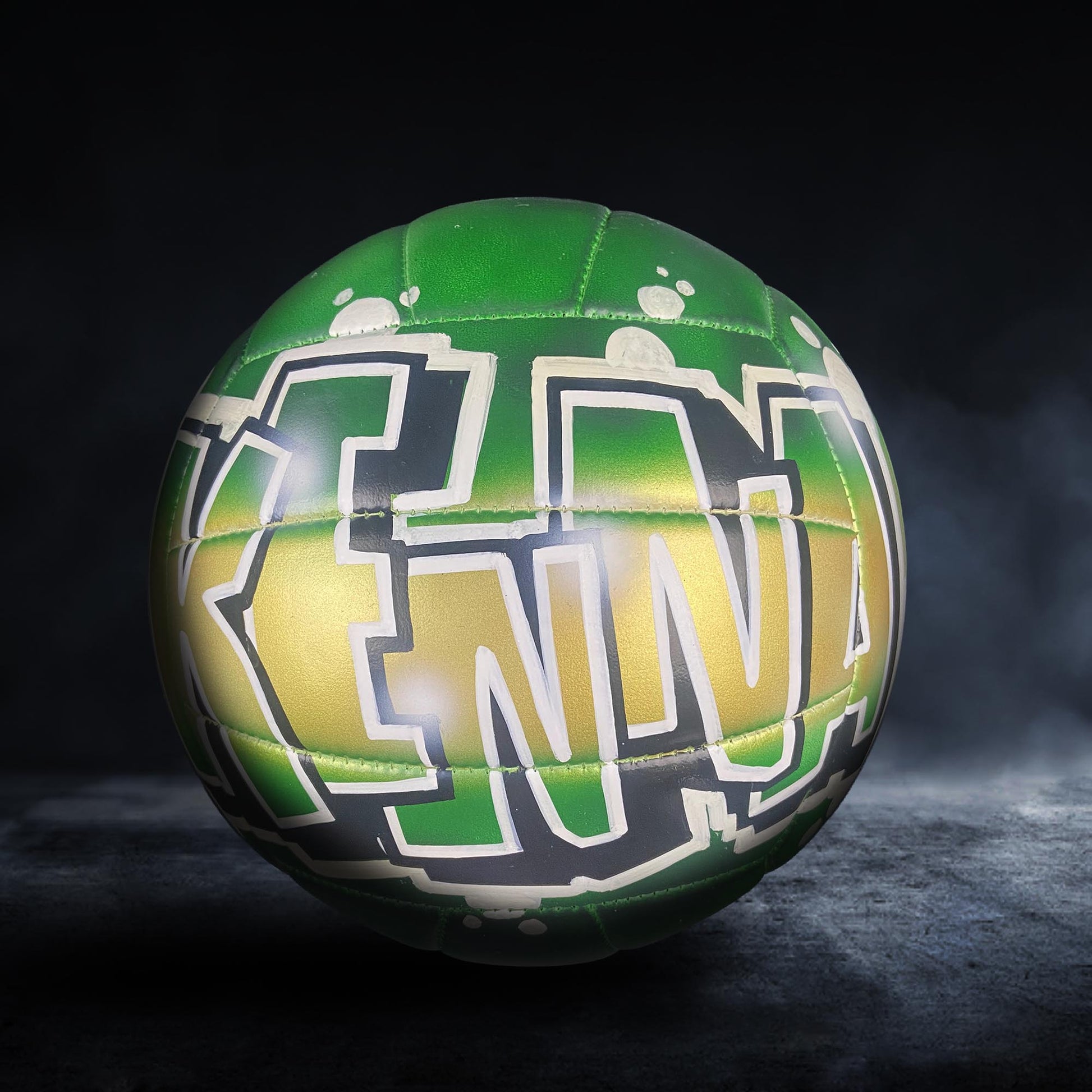 A green and yellow sports ball with the word "KENNA" written on it.