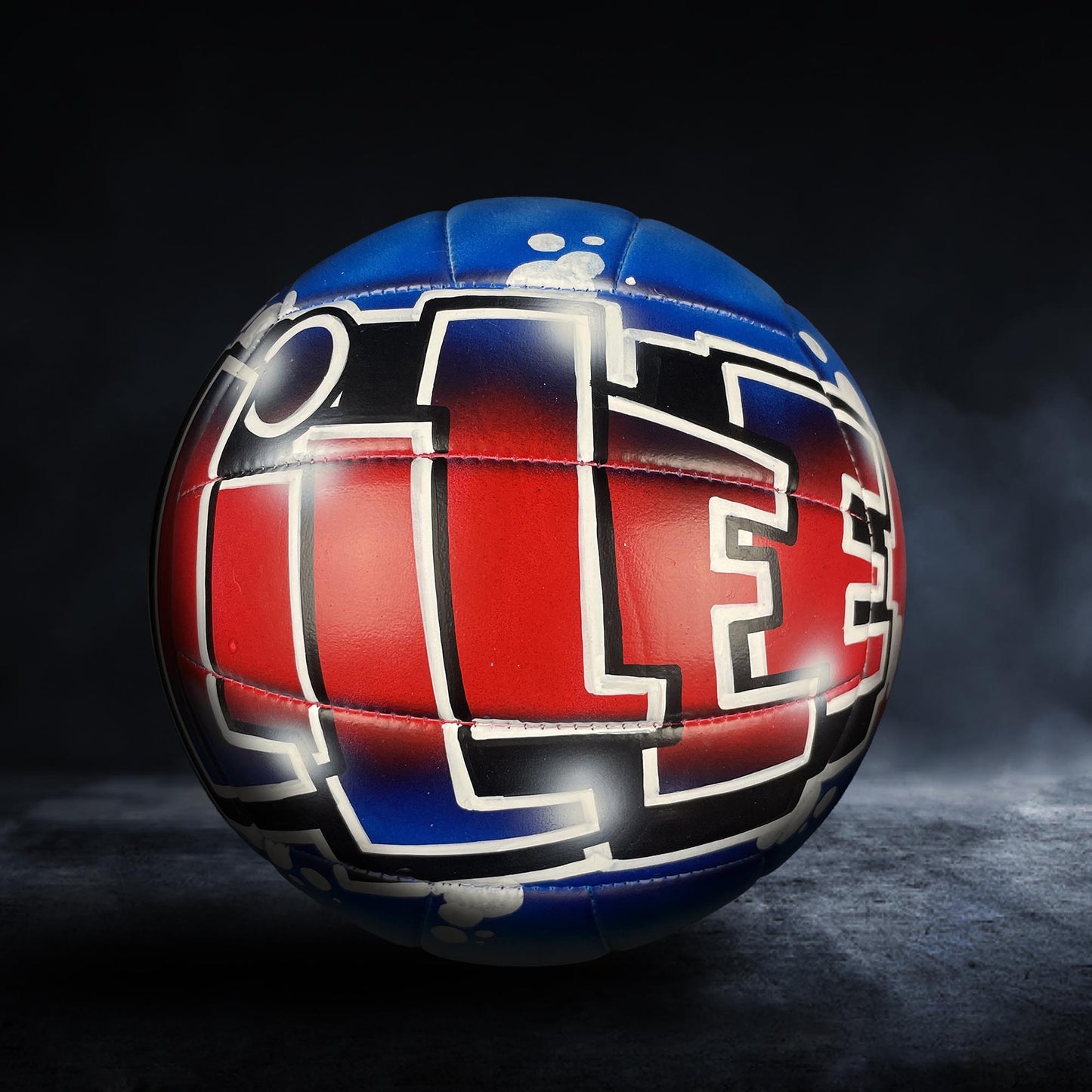 A colorful soccer ball with a red and blue design, featuring the word "ICE" prominently displayed.