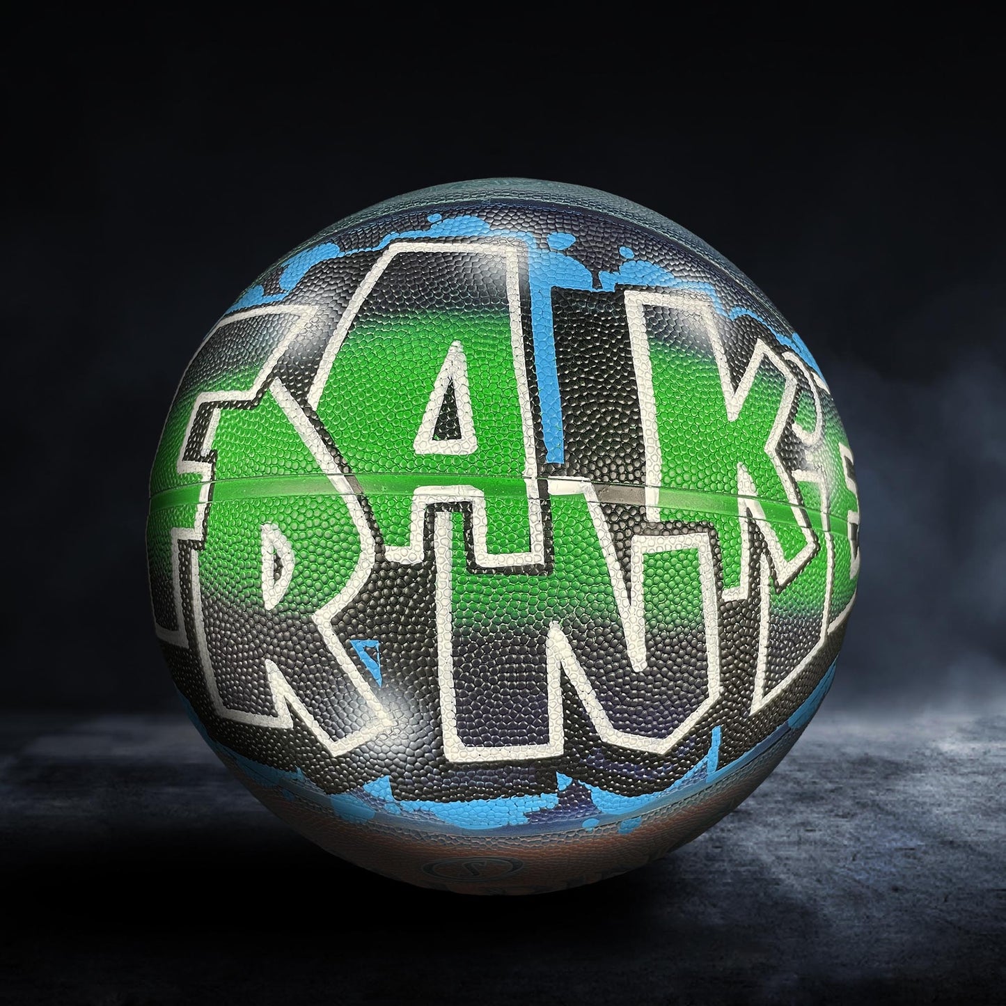 A basketball with the word "FRANK" painted on it in a stylized, graffiti-like design.