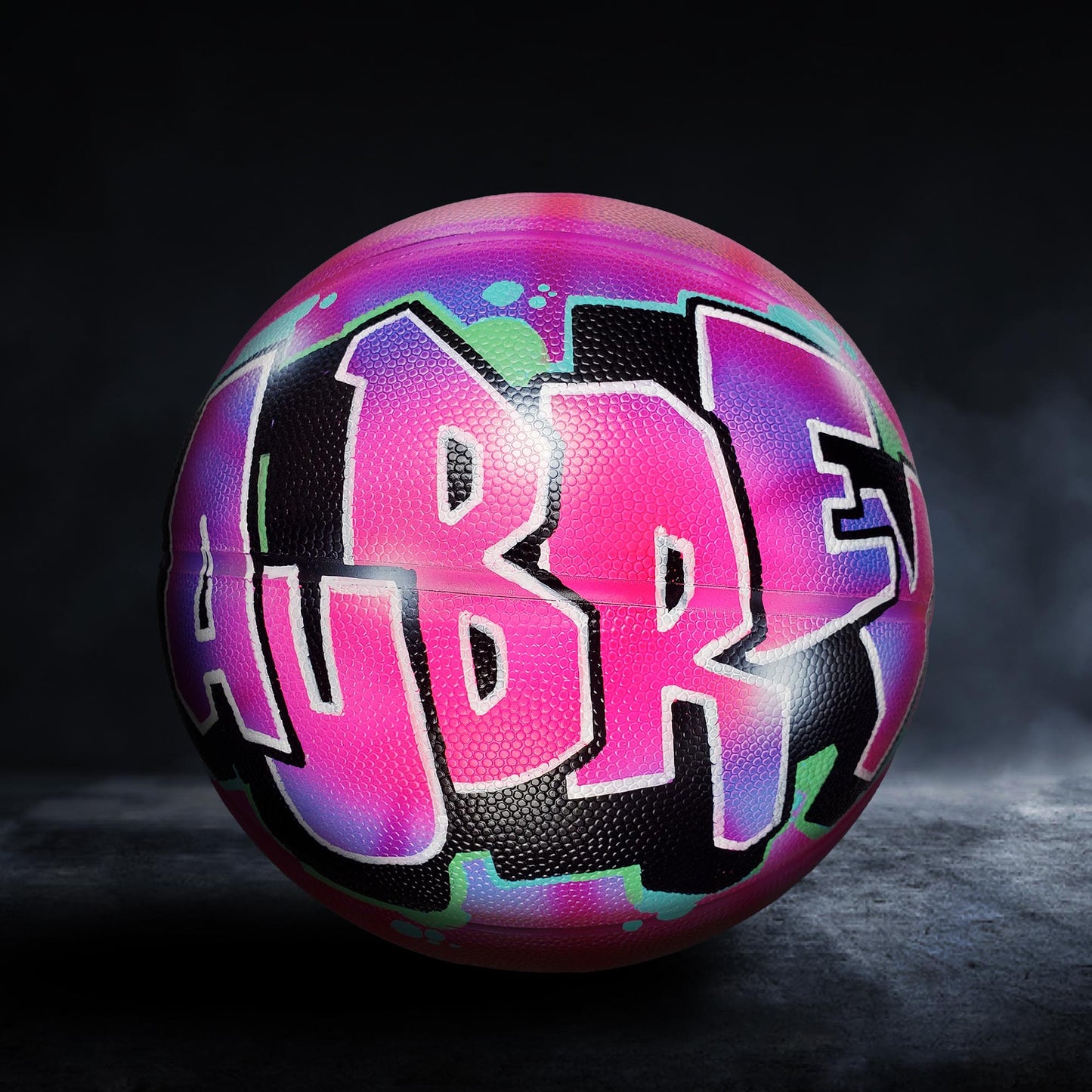 A colorful basketball with the word "UBRE" painted on it in a graffiti-style design.