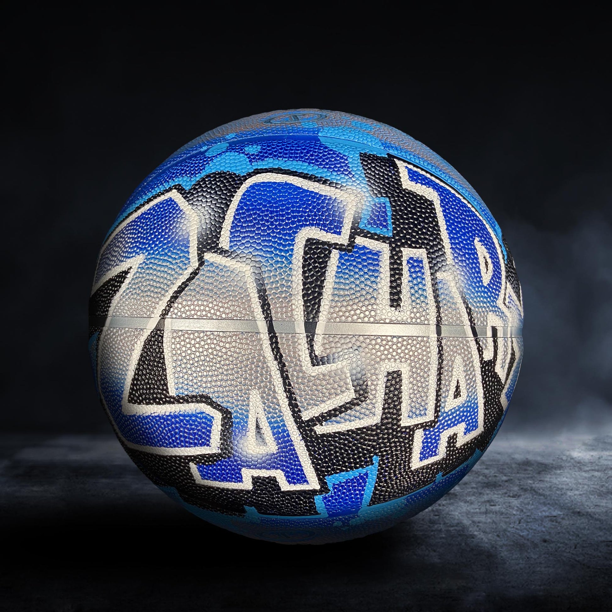 A basketball with a blue and black design featuring the name "Zach" written on it.