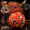 a basketball with graffiti on it, placed on a basketball court with a basketball hoop in the background.