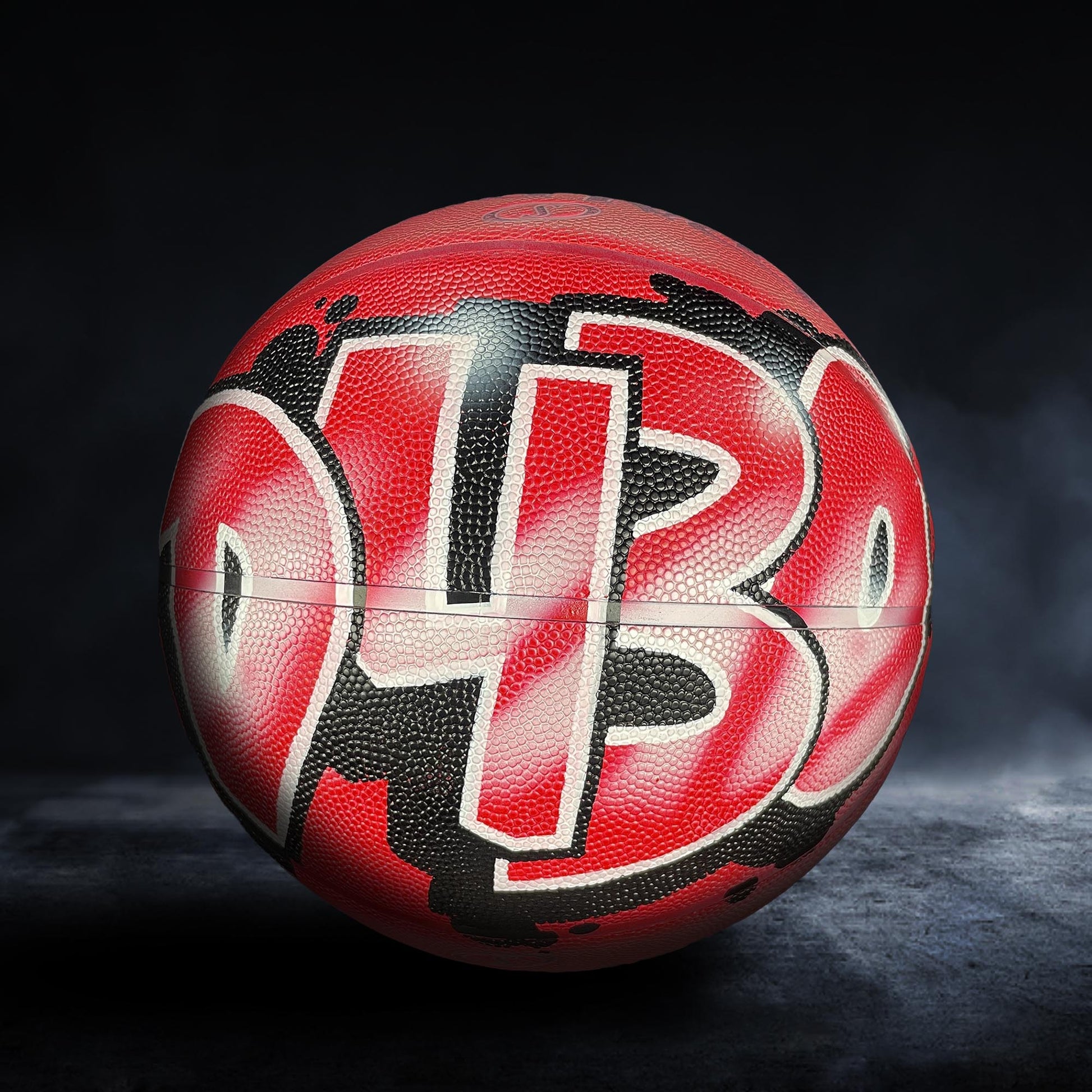 A red basketball with the number "4B" painted on it, standing on a dark surface.
