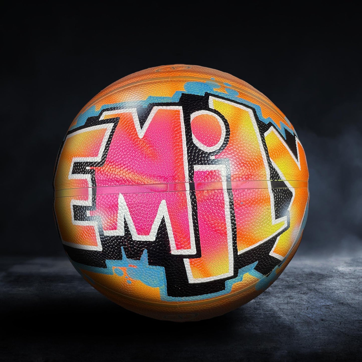 A basketball with a colorful, graffiti-style design on it.