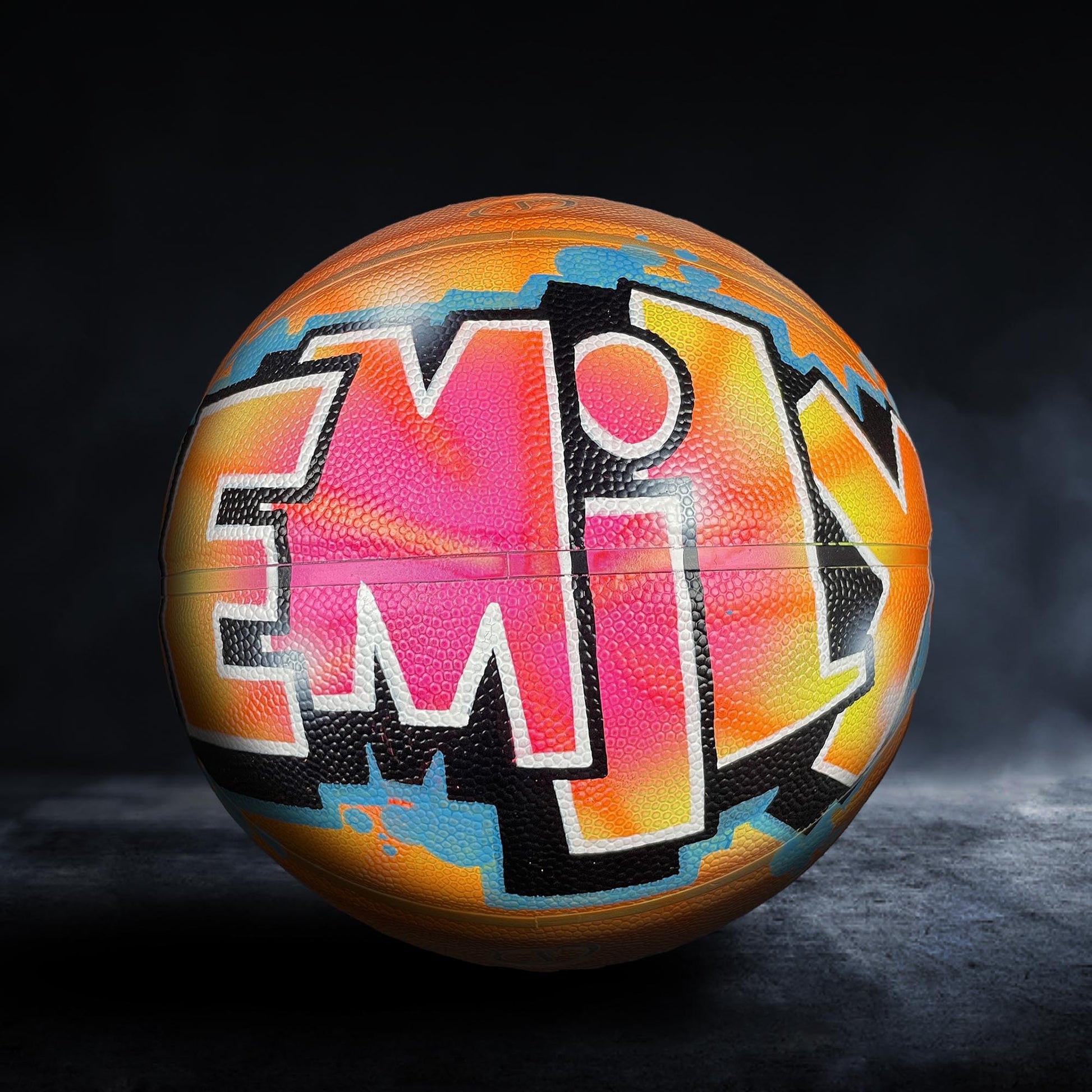 A basketball with a colorful, graffiti-style design on it.