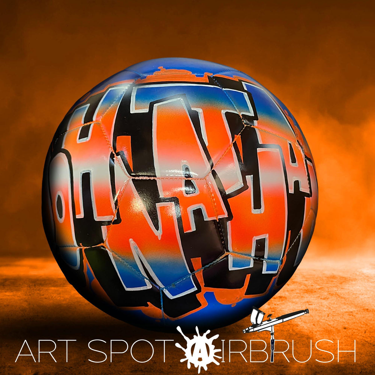A colorful soccer ball with graffiti-style text on it, set against an orange and brown background.