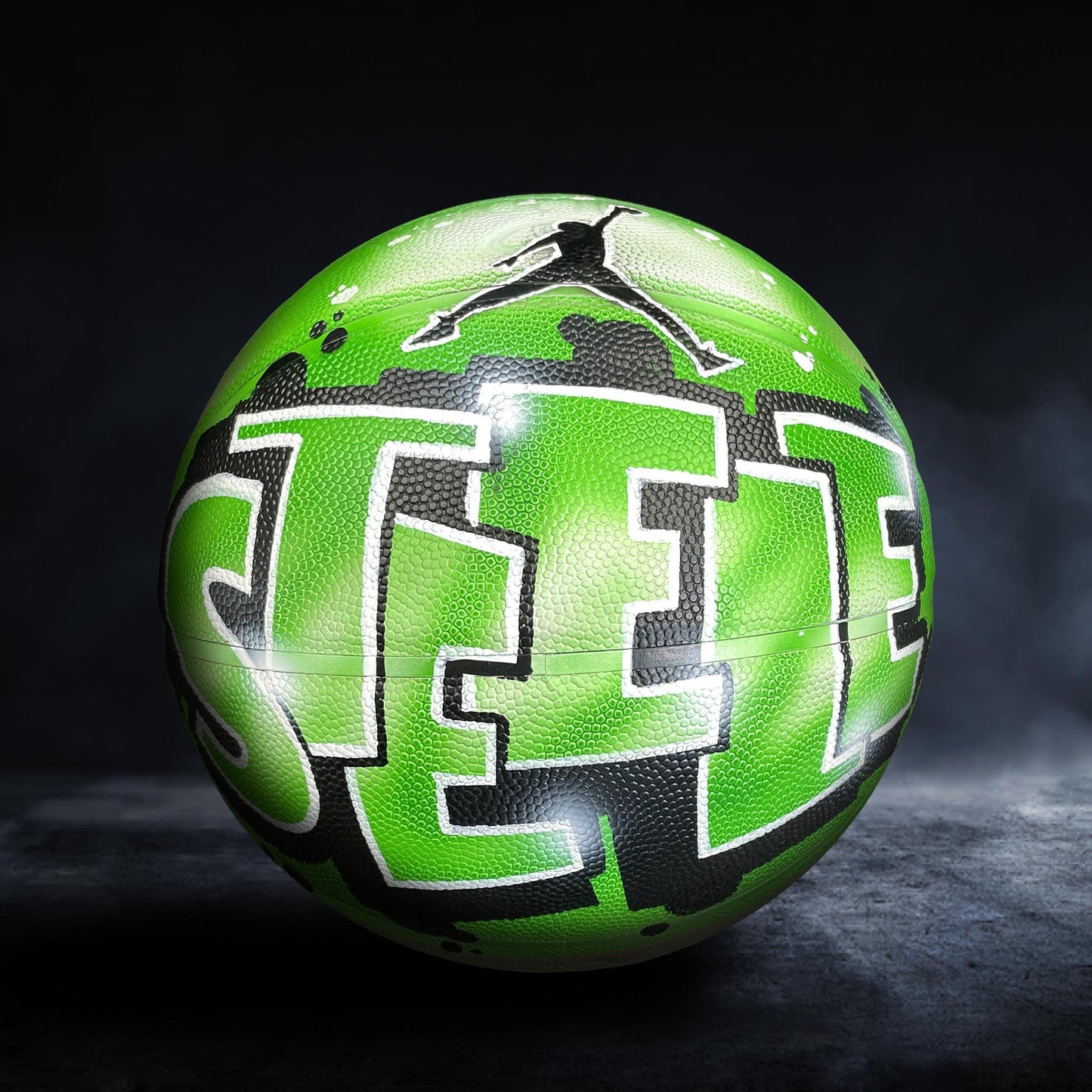 A green basketball with the word "SEE" painted on it, featuring a silhouette of a person in mid-jump.
