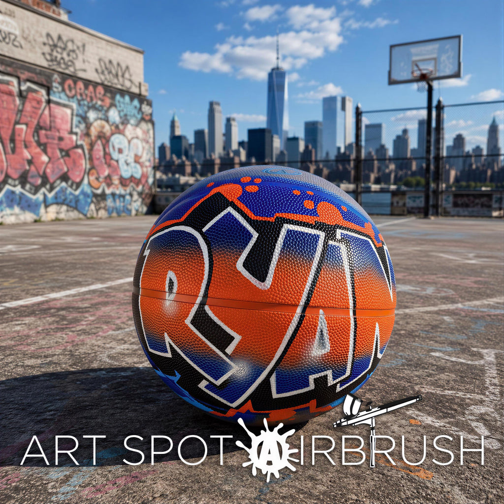 A basketball with the word "RAN" painted on it, sitting on a concrete surface in an urban setting with a city skyline in the background.