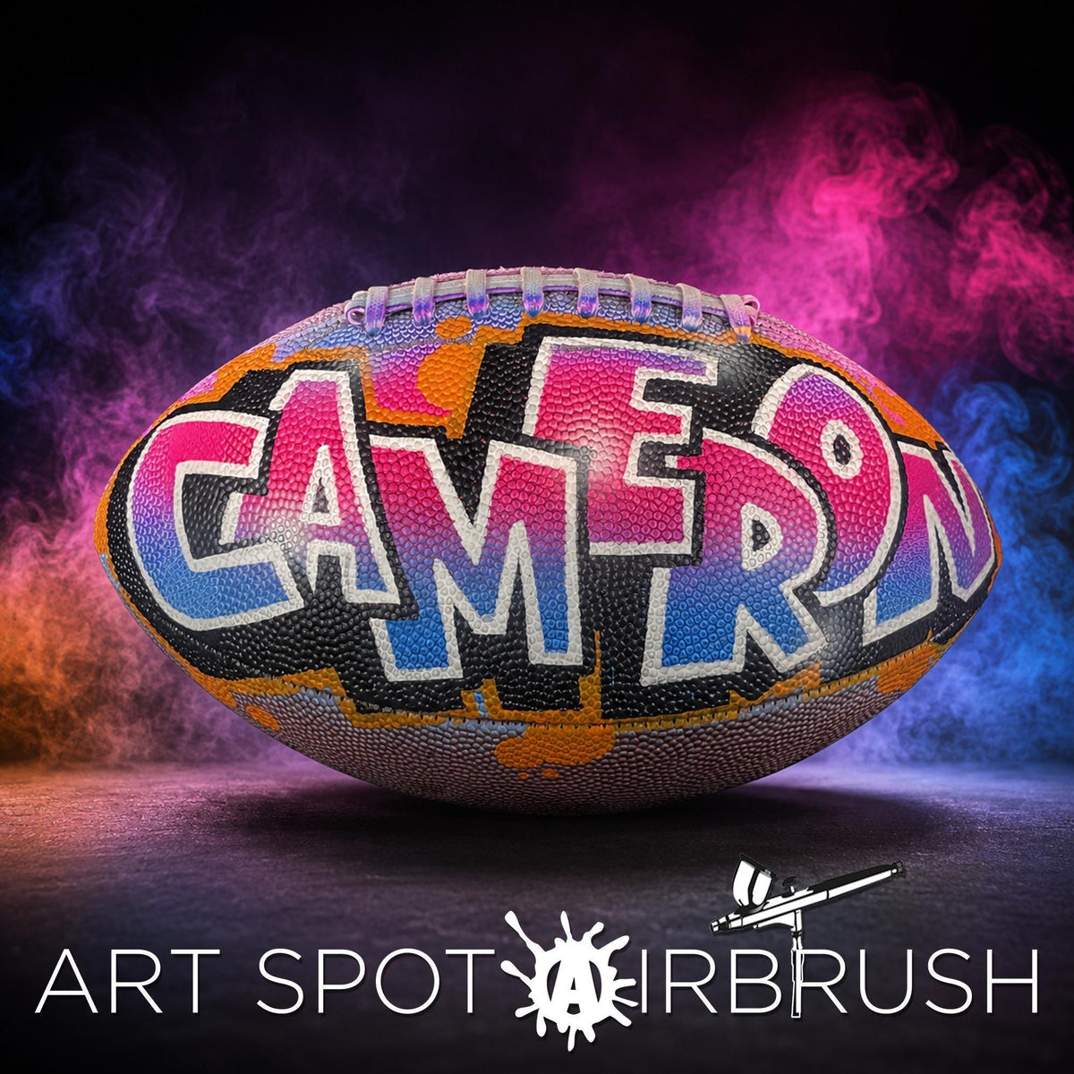 a personalized custom football with the name "CAMERON" painted on it
