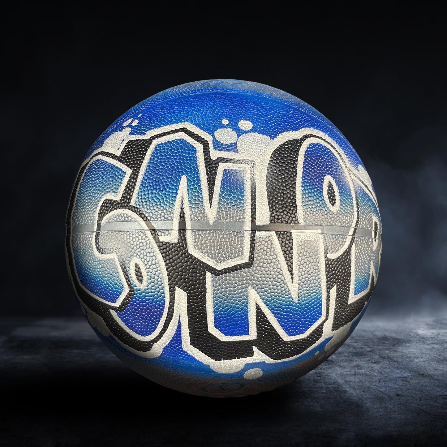 A blue basketball with the word "SNAP" written on it in graffiti-style lettering.