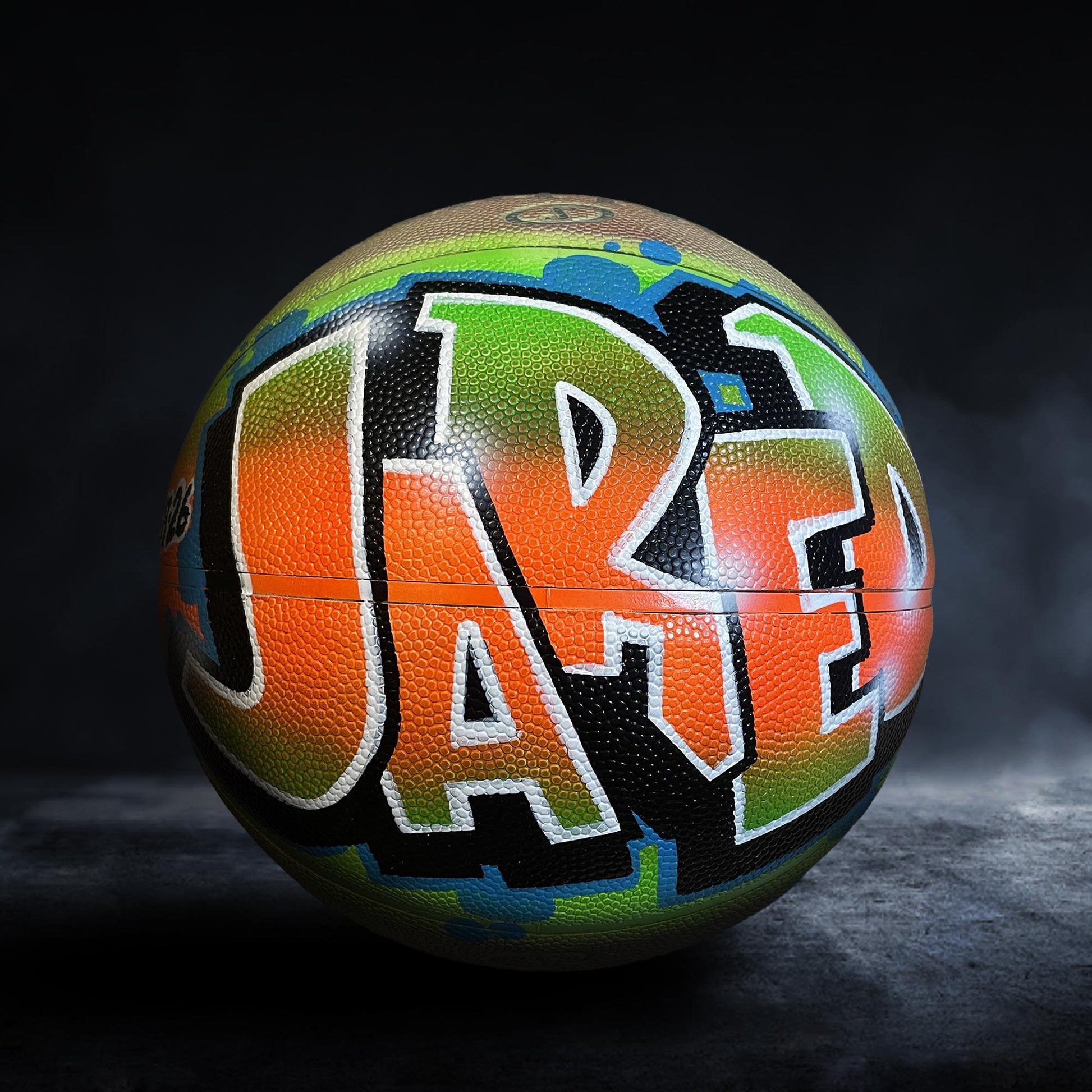 A colorful basketball with the name "Jared" painted on it.