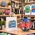 a store display with a white shopping bag and a soccer ball with colorful graffiti designs. The store appears to sell clothing and sports items, as indicated by the clothing racks and shelves in the background.
