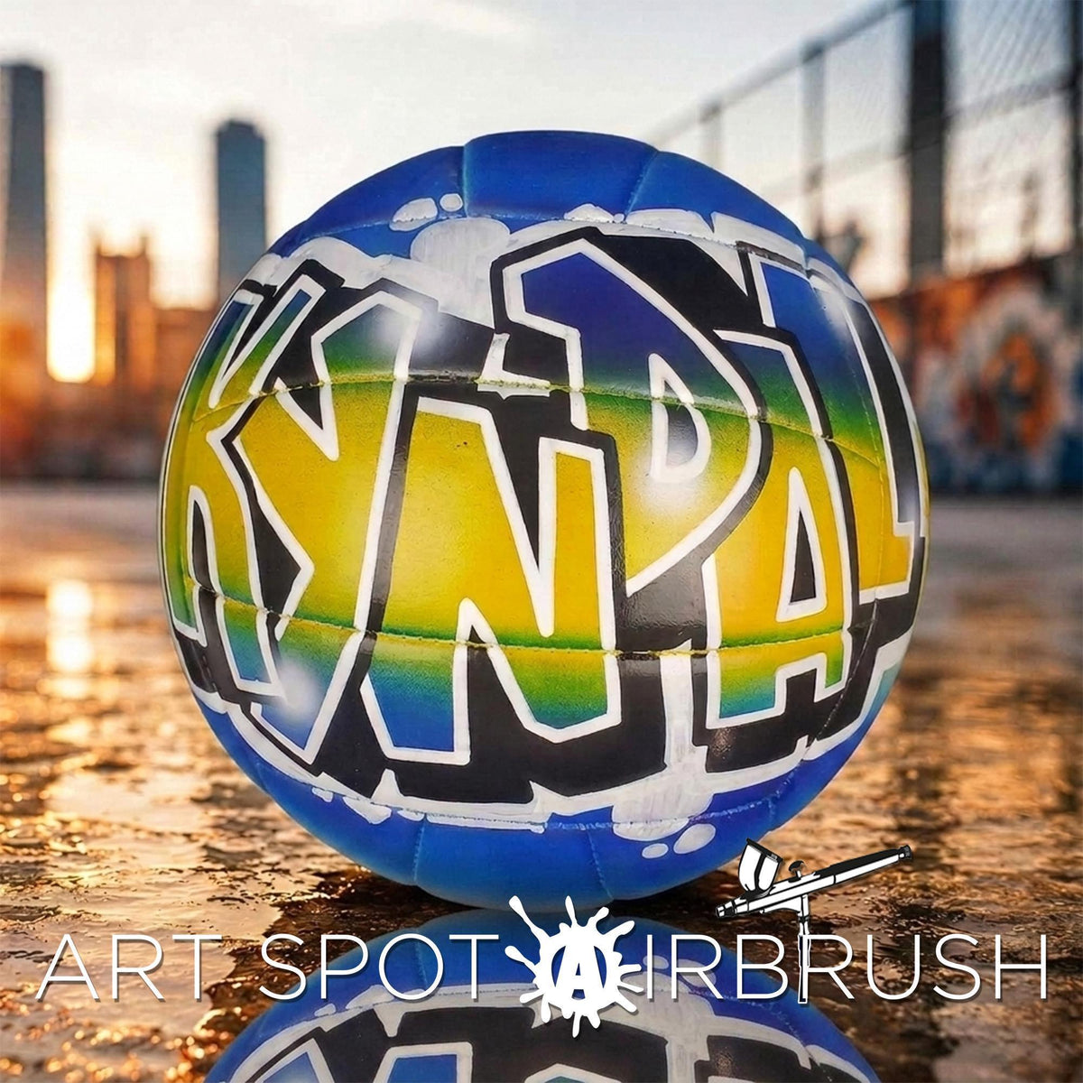 A colorful personalized custom volleyball with graffiti-style text on it, placed on a reflective surface with a city skyline in the background.