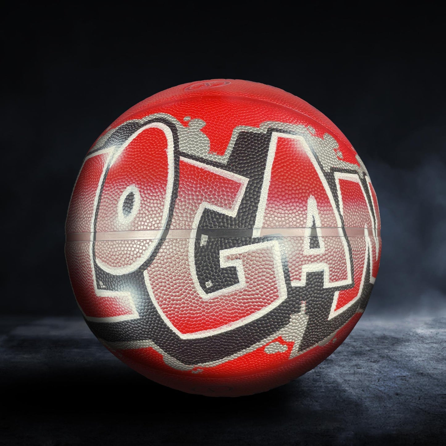 A red basketball with the word "Logan" written on it in graffiti-style lettering.