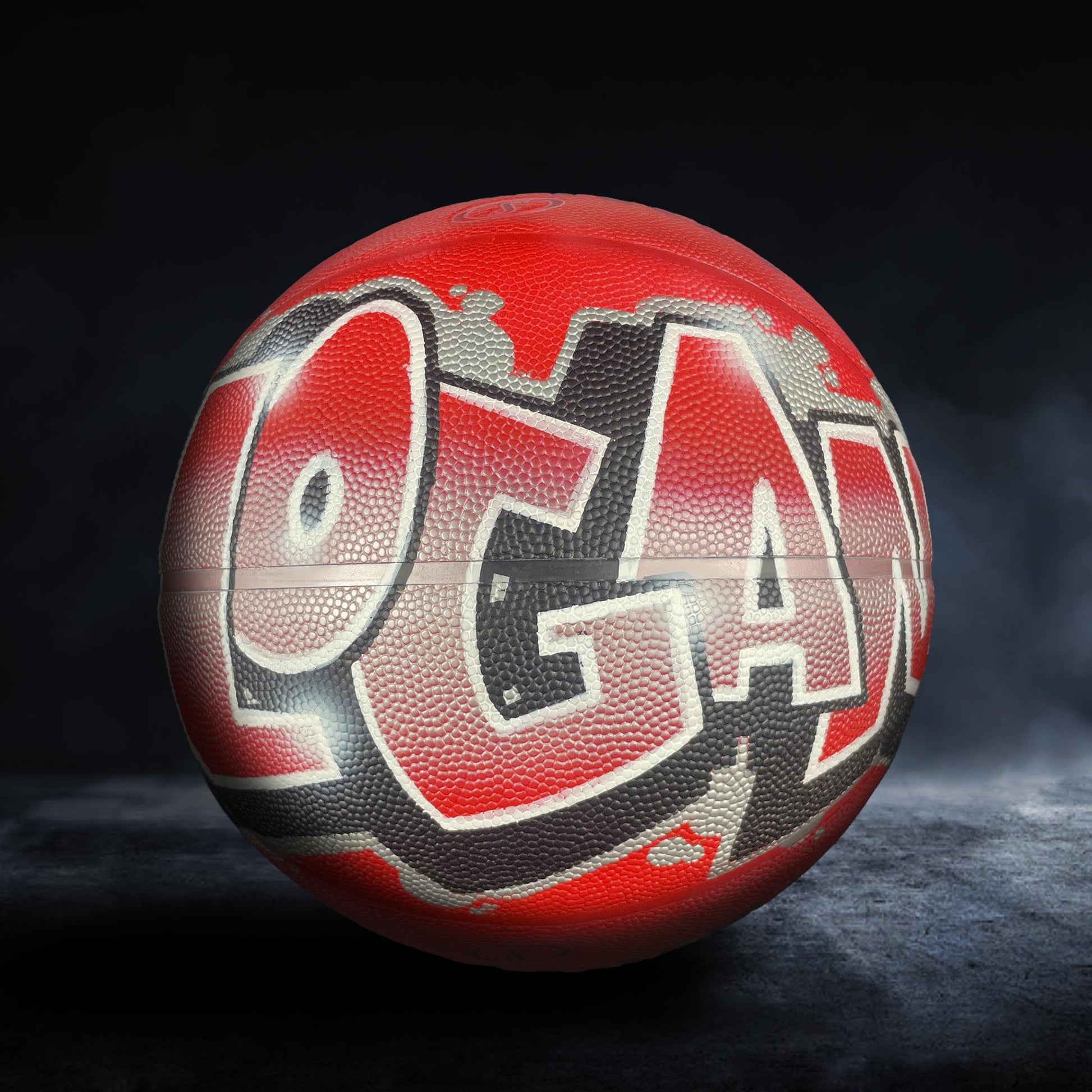 A red basketball with the word "Logan" written on it in graffiti-style lettering.