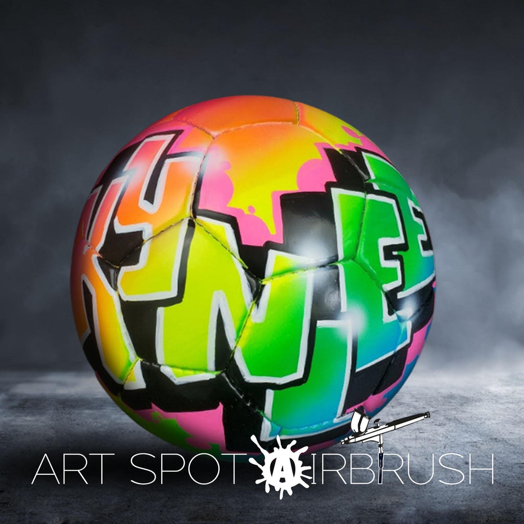 A colorful, graffiti-style soccer ball with the text "ART SPOT AIRBRUSH" displayed on it.