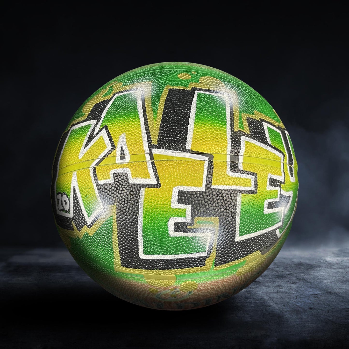 A basketball with the word "KALE" painted on it in a stylized, graffiti-like design.