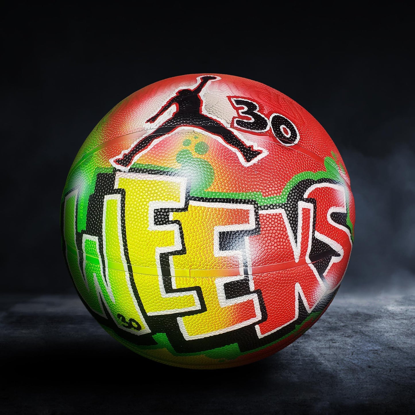 A colorful basketball with the word "JORDAN" painted on it, along with a graphic of a basketball player.