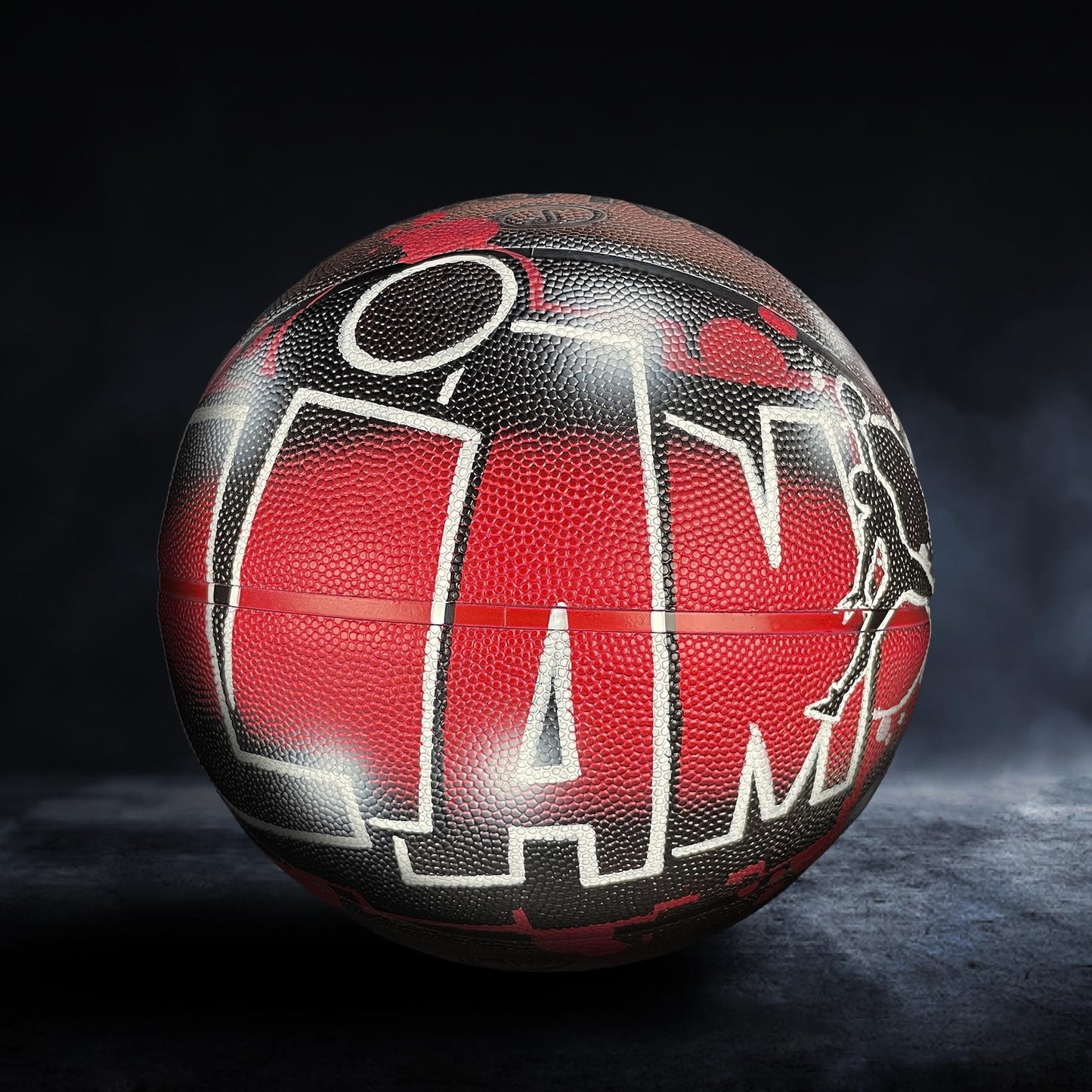 A basketball with a red and black design featuring the word "LAM" on it.