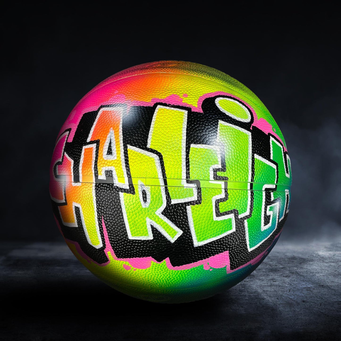 A colorful basketball with graffiti-style text on it, including the word "Harley" in various colors.