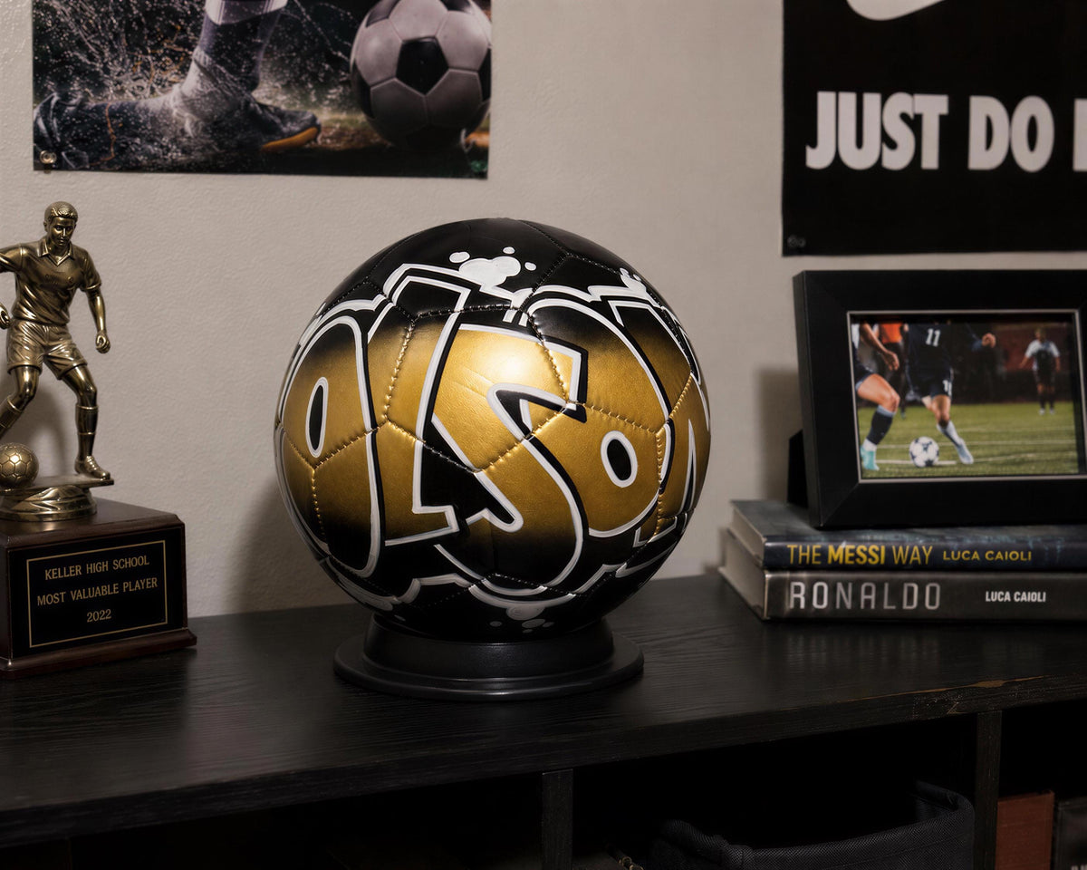 a trophy, a soccer ball, and a framed photograph on a shelf.