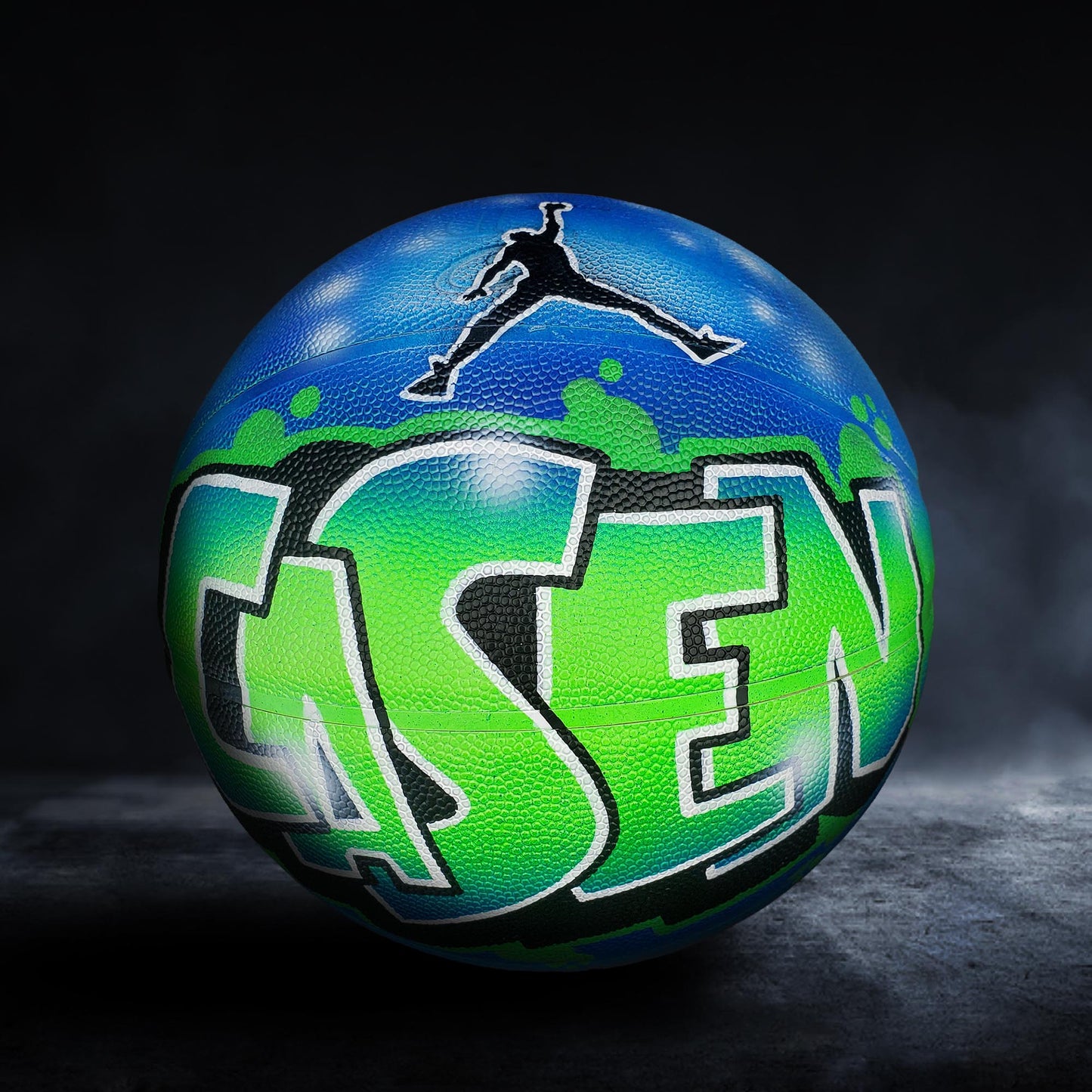 A basketball with the word "Jorden" painted on it, featuring a stylized graphic of a person in mid-jump.