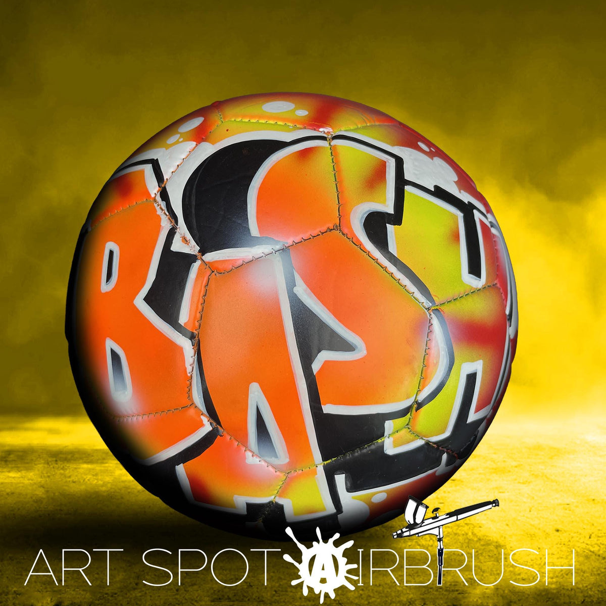 a colorful, graffiti-style soccer ball with the word "BAS" painted on it.