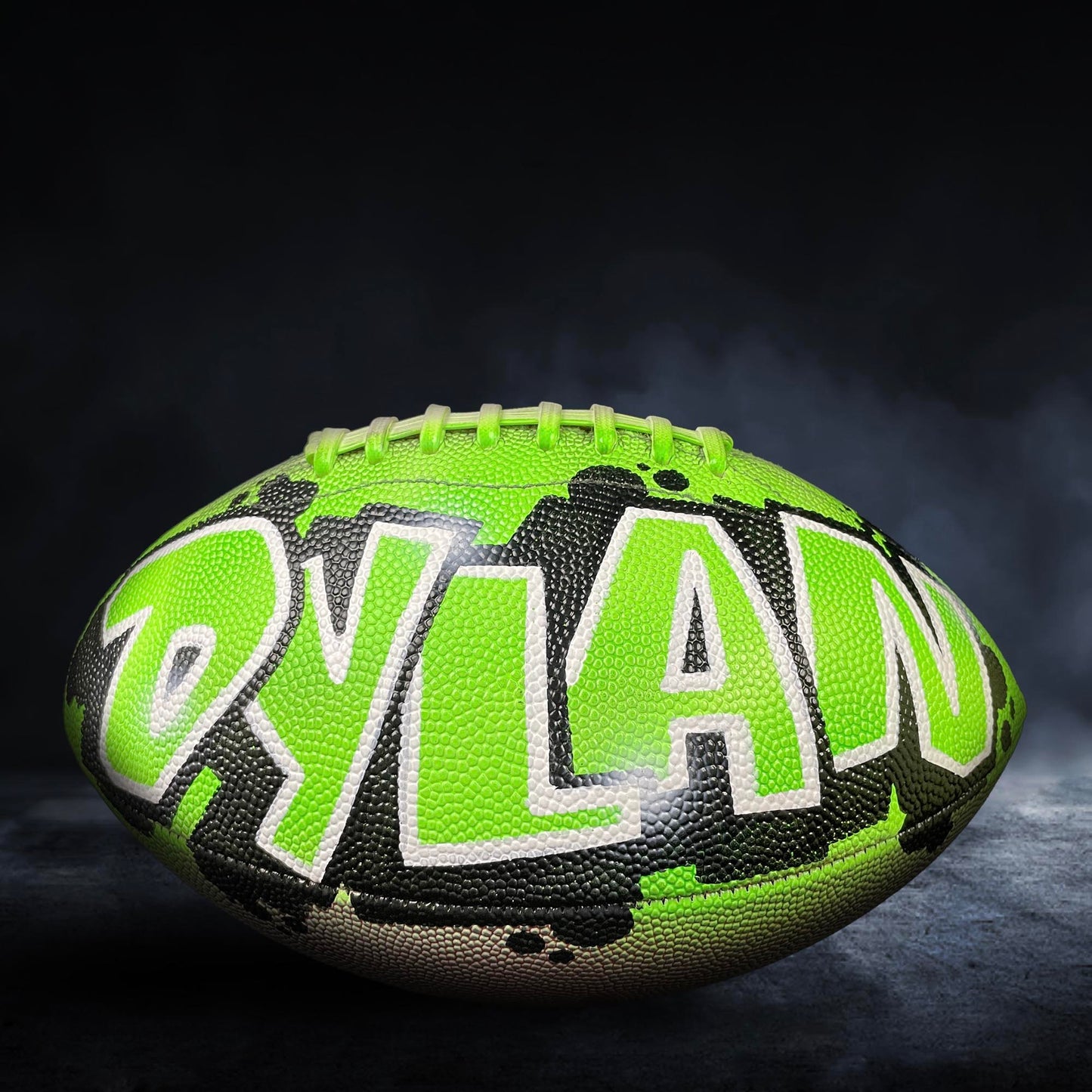 A neon green and black football with the name "Dylan" written on it.