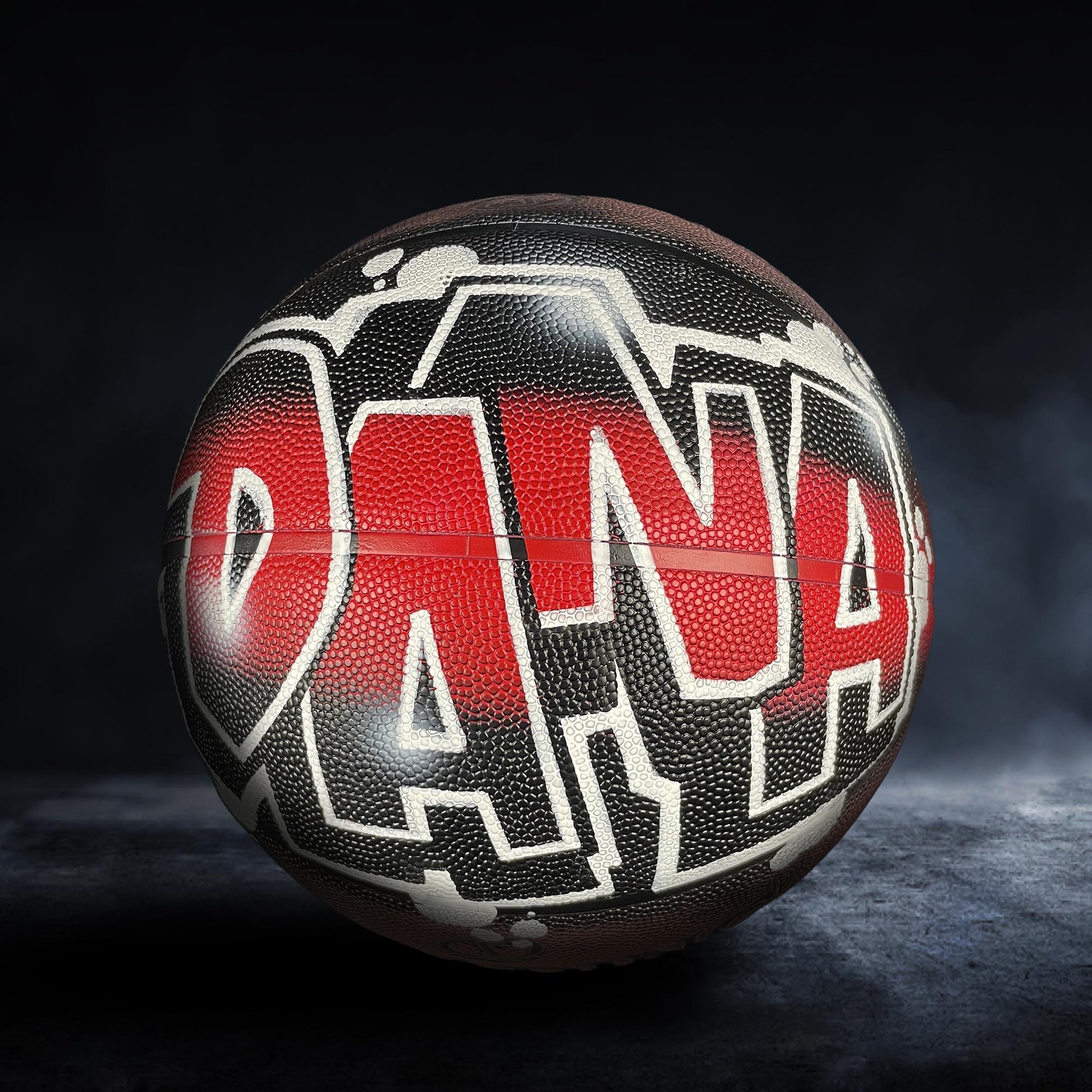 A basketball with the word "DANA" painted on it in a stylized, graffiti-like design.