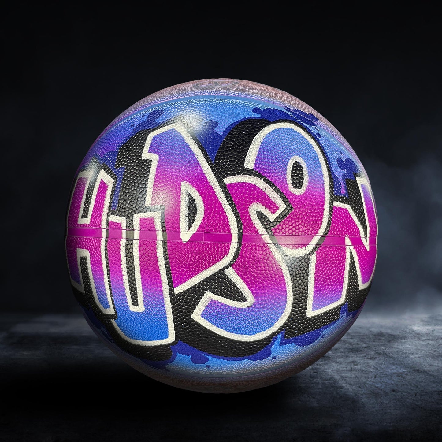 A basketball with the word "HIPPO" painted on it in a colorful, graffiti-style design.
